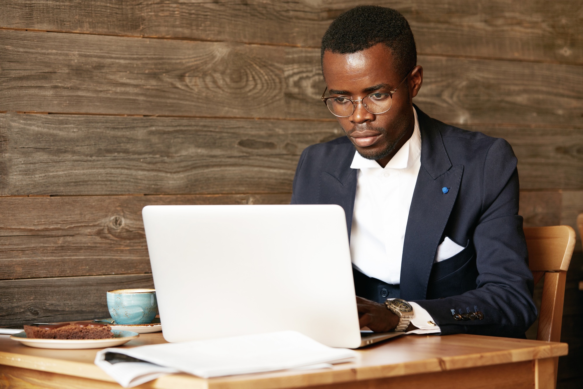 Business and success. Handsome successful African American man wearing formal suit, oval glasses and